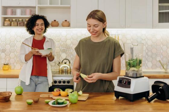 A support worker and a participant preparing a meal together in a kitchen